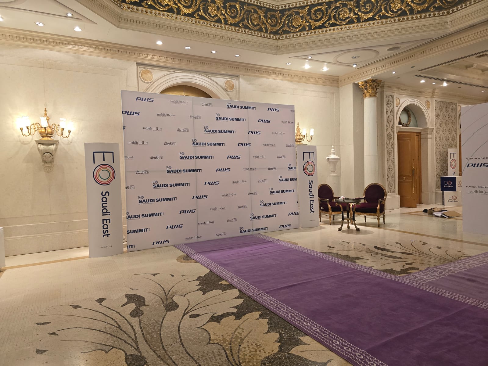 EO Saudi Summit step-and-repeat wall and purple carpet entrance