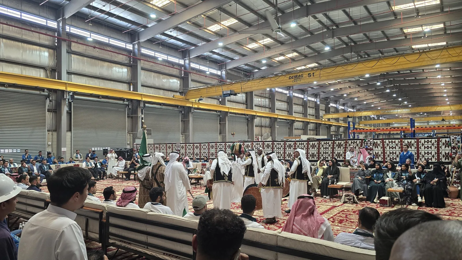 Folk troupe performing inside the hall majlis with seated audience