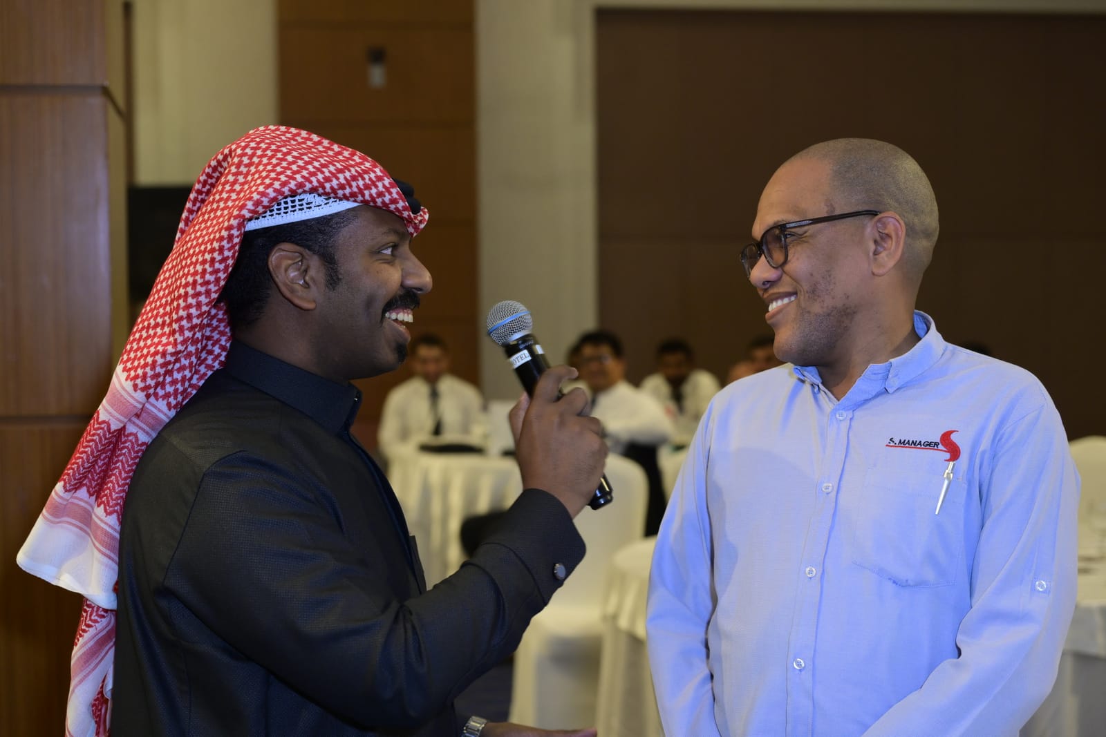 Live MC engaging Tamimi employee during quiz session