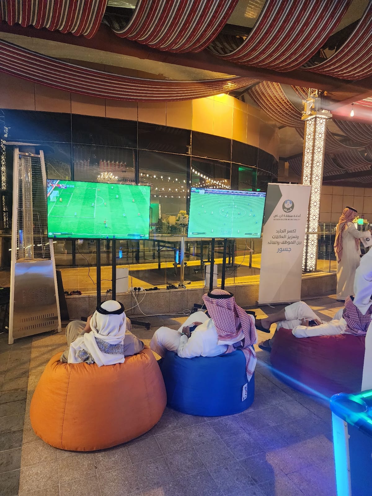 Games zone with bean bag seating and dual screens