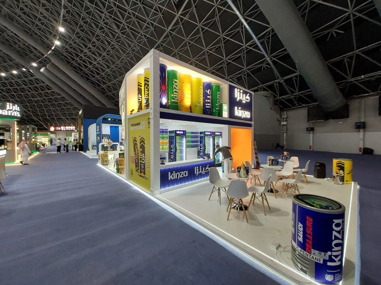 Kinza double-deck booth with lit product tower in expo hall