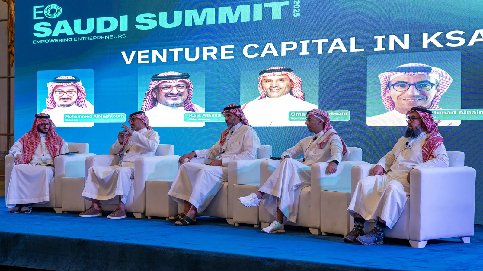 Venture Capital panel seated on stage under LED wall